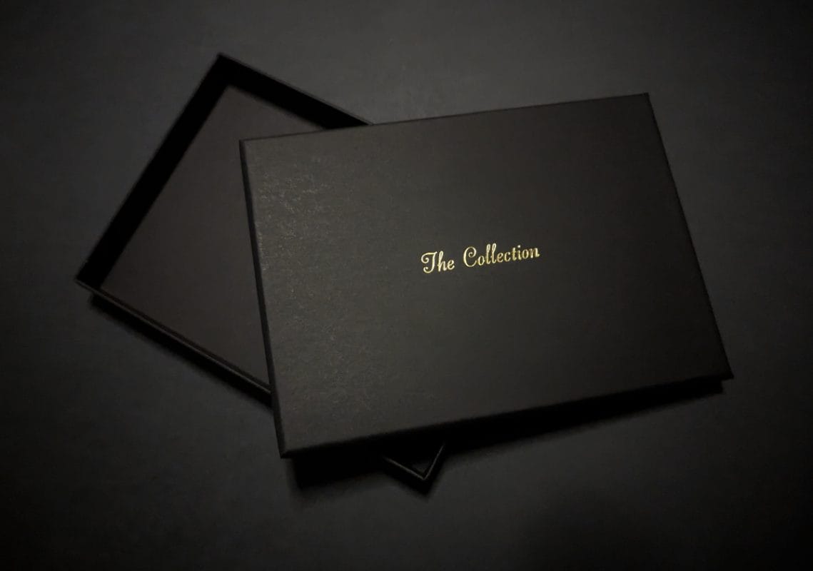 Black rigid presentation box with hot foil stamping.